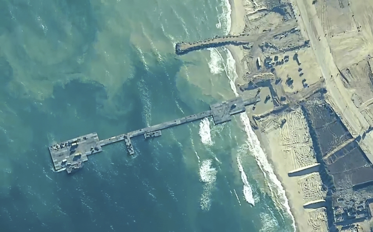 U.S. Army Soldiers assigned to the 7th Transportation Brigade (Expeditionary), U.S. Navy Sailors assigned to Amphibious Construction Battalion 1, and Israel Defense Forces emplace the Trident Pier on the Gaza coast, May 16, 2024. The temporary pier, part of the Joint Logistics Over-the-Shore capability, will enable the maritime delivery of international humanitarian aid to the United Nations in Gaza for distribution to Palestinian people in need.